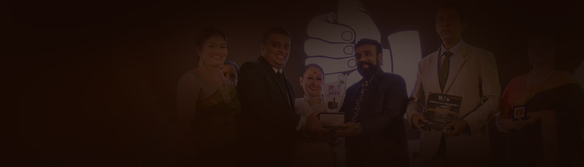 A dark background banner showing the O2 Cafe team proudly receiving the Pinnacle Sri Lanka 2025 award, recognizing our excellence in manufacturing and supplying tea and coffee premixes in Sri Lanka