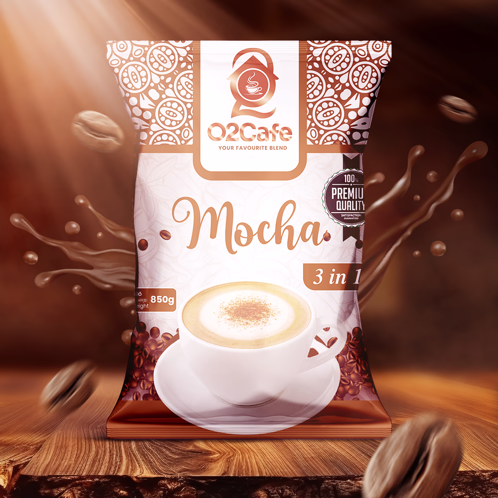 An 850g packet of O2 Cafe Mocha 3-in-1 resting on a wooden surface surrounded by dynamic splashes and roasted coffee beans, adding to our premium range of coffee premixes in Sri Lanka
